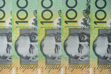 Australian one hundred dollar bills circle pattern on white background.