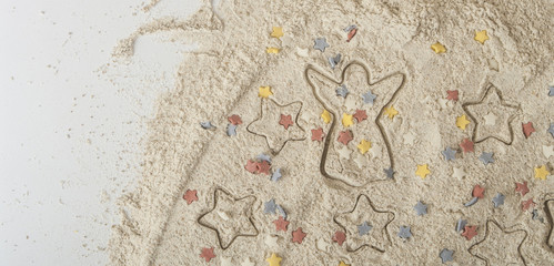 Abstract Christmas food background with cookies molds and flour