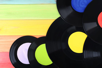 Vinyl records on colourful wooden table