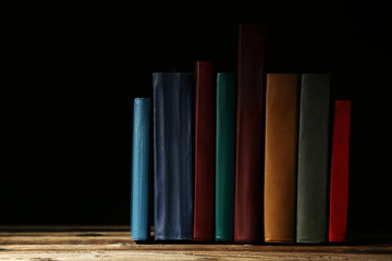 Old antique books on brown wooden table