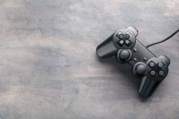 Black joystick on a grey wooden table © 5second