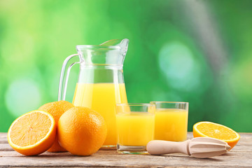 Glass of orange juice on wooden table