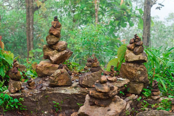 Fototapeta na wymiar Stacked stones in the forest green background.Thailand.