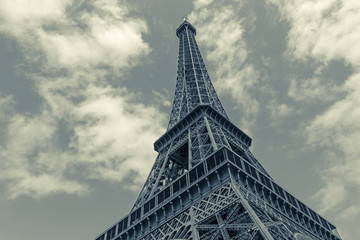 Eiffel tower in Paris against sky with clouds