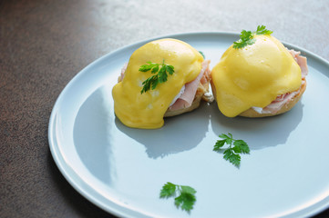 Eggs Benedict- toasted English muffins, ham, poached eggs, and delicious buttery hollandaise sauce