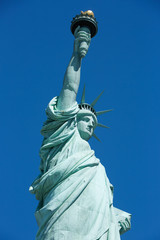 Obraz na płótnie Canvas Statue of Liberty low angle view, blue sky in New York