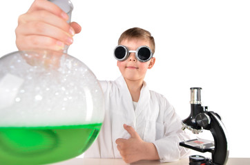 Scientist boy in black glasses hold big flask and shows thumbs up
