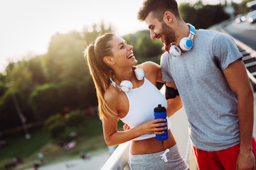 Portrait of man and woman during break of jogging