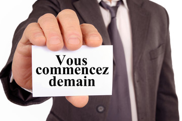 Homme tenant une carte avec &eacute;crit vous commencez demain 