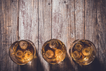 Whiskey glasses on an old wooden table. Close up