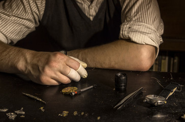 The watchmaker is repairing the mechanical watches in his workshop