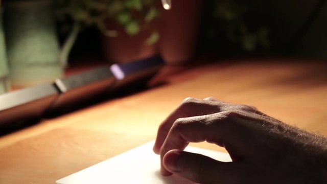 Hand using touch pad with iMac