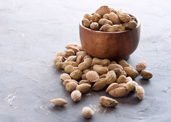 Wooden bowl with unpeeled nuts Nuts Almond peanuts Healthy snack