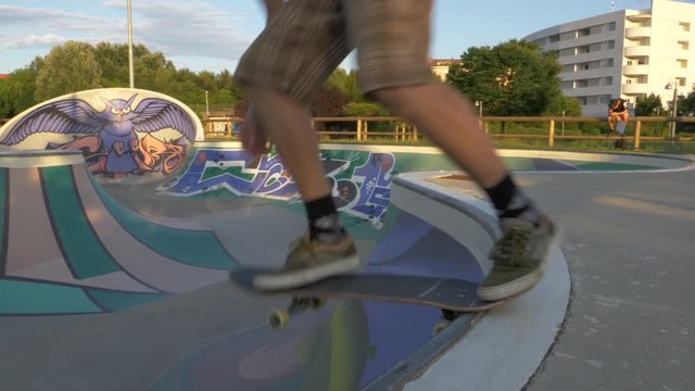 Skateboarder going down on Concrete Skatepark Ramp - Slow Motion