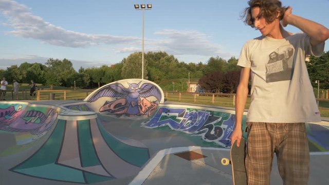 Skateboarder  looks at the camera and smiles – Slow Motion