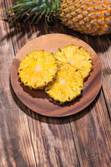 Obraz na płótnie Canvas Fresh sliced pineapple on a wooden background.
