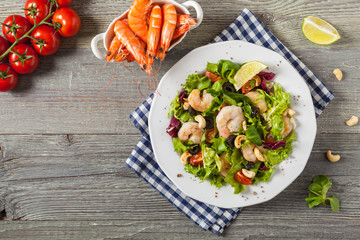 Shrimp salad with tomato, olives and cashew nuts.