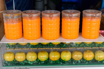 Orange juice in plastic jug in the market.Thailand.