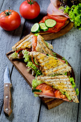 Panini sandwich with ham, tomato and lettuce.