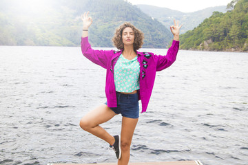 young woman meditating yoga outdoors