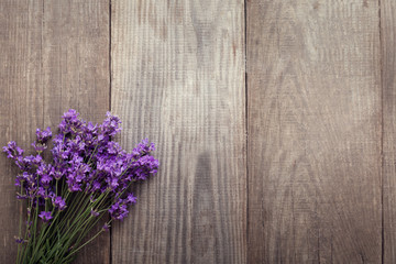 Bouquet of summer lavender on an old wooden background (top view)