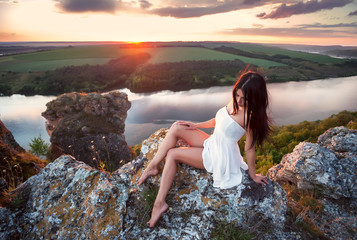 Freedom Concept.Beautiful Girl  on the Rock. Flying.Free.Vacation