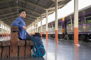 man traveler with backpacker at trainstation