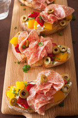 salami bruschetta with roasted peppers goat cheese olives