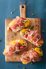 salami bruschetta with roasted peppers goat cheese olives