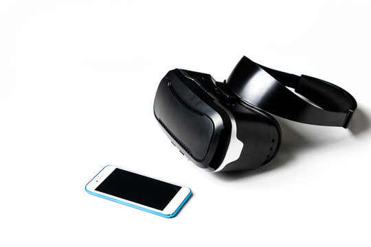 virtual reality goggles and smart phone on white background.