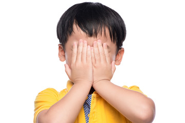 Young asian boy shy or scared, hide his eyes by hands.