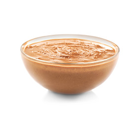 Peanut butter in glass bowl on white background