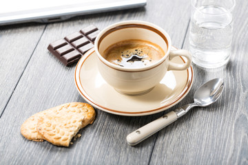 A cup of coffee and biscuits