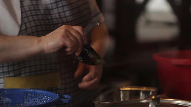 Woman opening mussel