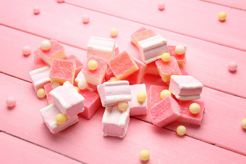 Composition of delicious candies on pink table