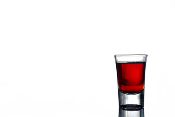Glass of alcohol on a white background. Free space for text
