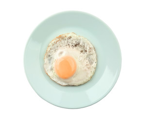 Plate with fried sunny side up egg on white background