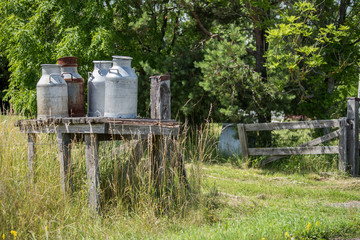 Traditional milk churn stand along a countryroad on Swedish Baltic sea island Öland for transport of milk cans to the dairy 