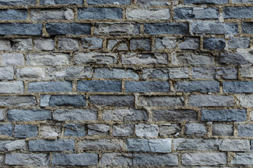 Ruined wall of brick gray.