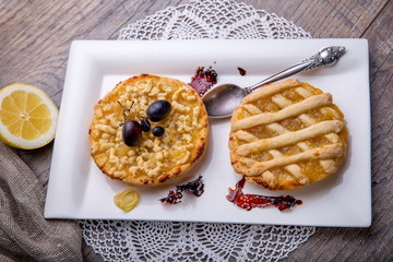 Breakfast for two, lemon tarte and tea on wooden table