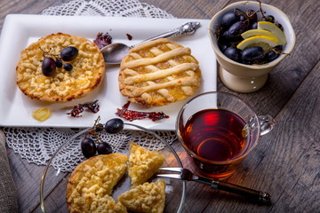 Breakfast for two, lemon tarte and tea on wooden table