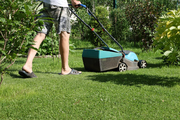 Senior man mowing lawn