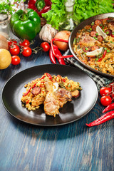 Traditional paella with chicken legs, sausage chorizo and vegeta