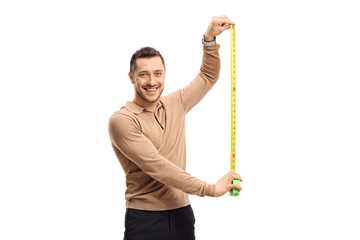 Young guy with a measuring tape looking at the camera
