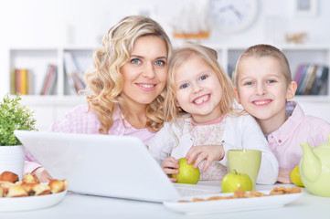 mother and children with laptop