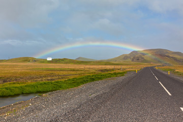 Fototapeta na wymiar Rainbow and Endless Icelandic Highway