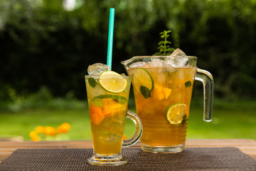 Homemade peach ice tea with lime and lemon balm