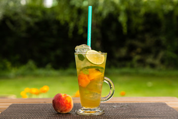 Homemade peach ice tea with lime and lemon balm