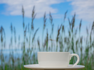Coffee espresso on wood table nature background on the beach, Beauty nature background