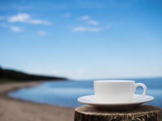 Coffee espresso on wood table nature background on the beach, Beauty nature background